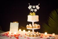 A top wedding cake and a combination of cupcakes