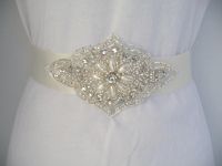 This bridal sash features Handmade Ivory satin double-faced satin ribbon adorned with  an elegant genuine rhinestone and pearl embellishment.  All hand sewn.  Custom orders welcome.  Buy at www.BellaCescaBoutique.Etsy.com