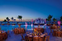 www.crystalwaterweddings.com Experienced travel agents who strongly value providing first class service and have a deep passion for destination weddings. 

Secrets Capri Riviera Cancun 
Mayan-themed party is set up for a large group on the pool deck.
